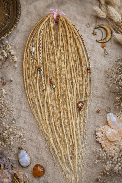 Honey blonde double ended synthetic dreadlocks with loose curls