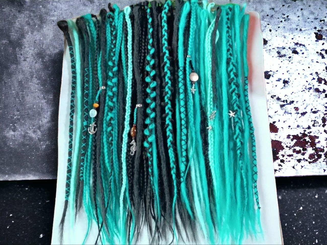 Statement-Making Teal and Black Dreadlocks: Trendy Hairpiece for a Bold Hairstyle