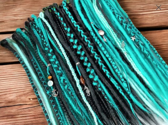 Statement-Making Teal and Black Dreadlocks: Trendy Hairpiece for a Bold Hairstyle